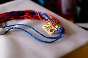 A red and blue tassel with a gold 2013 hanging from it