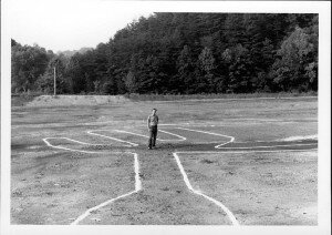 Man standing inside giant white lines shaped like the outline of a claw